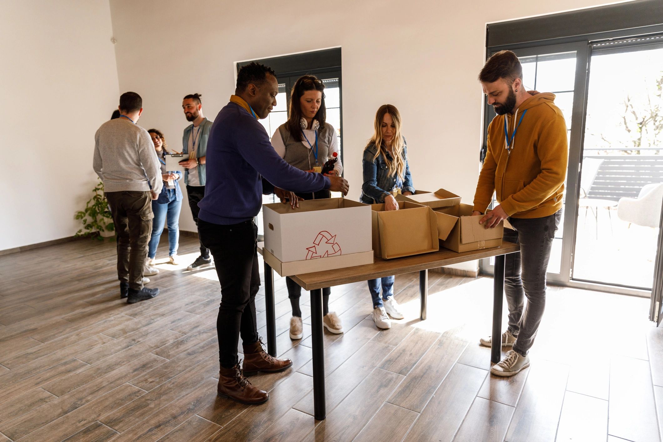 People organizing donation boxes at a volunteer center
